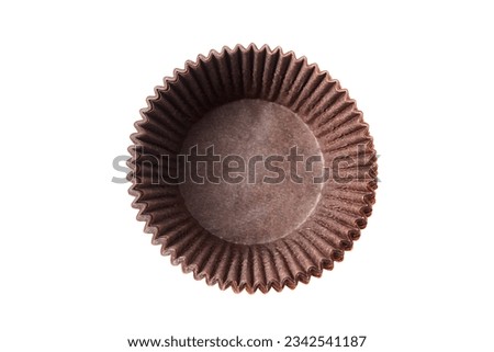 Empty cupcake baking cases pack isolated on white background, top view. Brown greaseproof paper baking cups. Muffin cases, cupcake liners Royalty-Free Stock Photo #2342541187