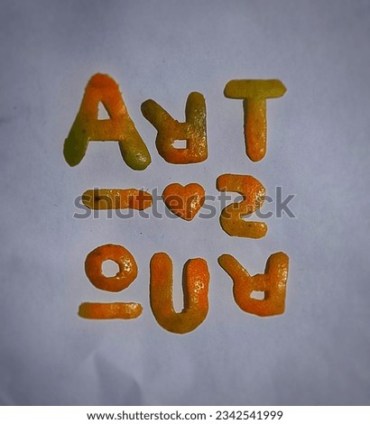 the inscription ART IS OUR is made of pieces of orange peel on white paper.
