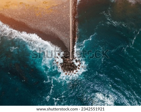 ocean blue water waves and stone breakwater with black beach, Tenerife, Canary Royalty-Free Stock Photo #2342551921