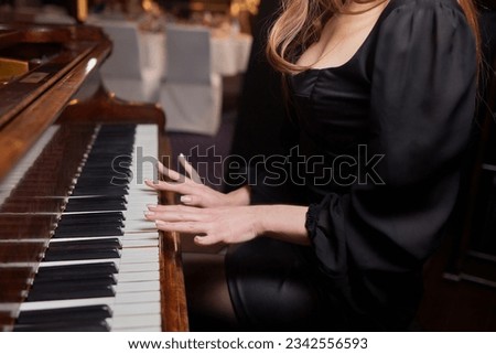 Close up of young girls hands, playing piano