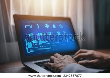 A person using a laptop with a smart home and office automation control application on it - the concept of innovative technologies
