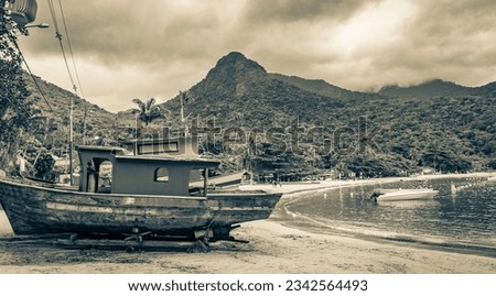 Black and white picture of old boats ships and boats for restoration in Abraao beach Ilha Grande Angra dos Reis Rio de Janeiro Brazil.
