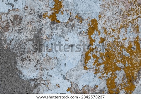 Vintage wall texture. Rough surface of the plastered concrete wall of the building. A pattern with many cracks and old faded peeling paint. Perfect for background and design. Closeup. Royalty-Free Stock Photo #2342573237