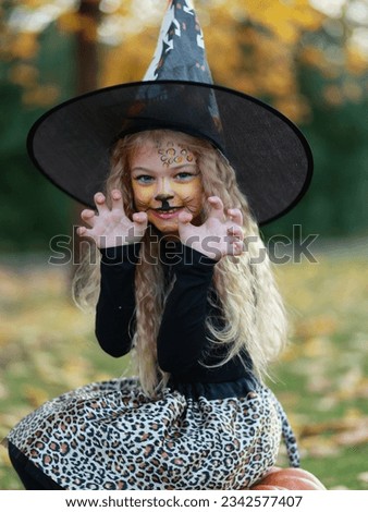 Little girl celebrates Halloween in the park