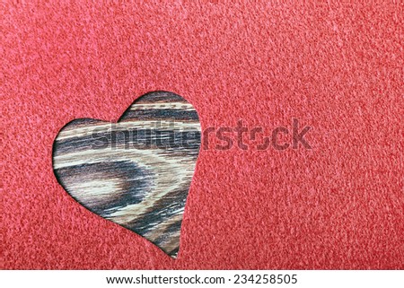 heart cut from felt on wood background