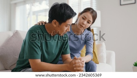 Asia young people stress relief trust talk share suffer cancer pain sick family loss bad news crisis. Sorrow cry man and carer woman sit at sofa home help listen by love hold hand warm hug touch wife. Royalty-Free Stock Photo #2342605369
