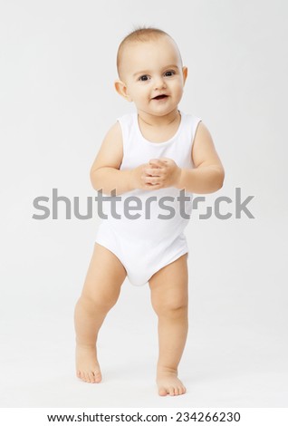 sweet gentle boy standing on white background and smiling