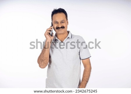 Indian man talking on mobilephone Royalty-Free Stock Photo #2342675245