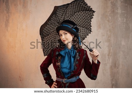 Mary Poppins. A stylish lady in a burgundy old - fashioned suit with a hat and a lace umbrella . Brunette in a retro style suit Royalty-Free Stock Photo #2342680915