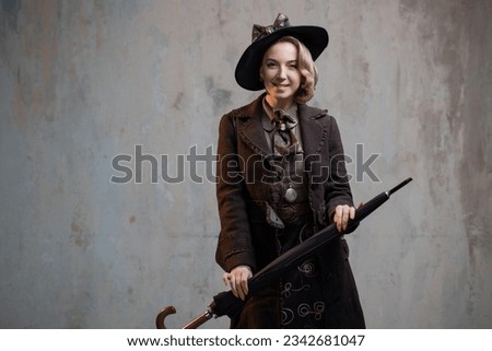A stylish lady in an elegant Victorian-style suit, wearing a hat with an umbrella in her hands Royalty-Free Stock Photo #2342681047