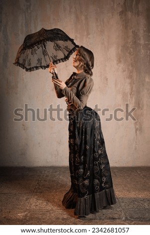 A stylish lady in an elegant suit in the Victorian style, a suit in the style of Mary Poppins, a kind teacher Royalty-Free Stock Photo #2342681057