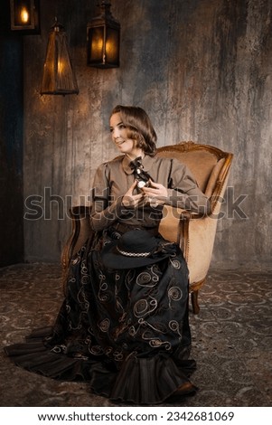 A stylish lady in an elegant Victorian-style suit, sitting in an armchair. costume with steampunk elements, Royalty-Free Stock Photo #2342681069