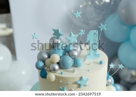 first birthday cake decorated with balloons and stars