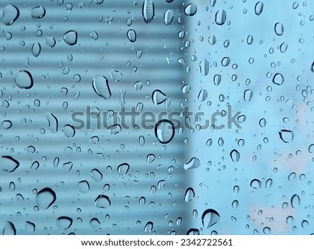 a photography of a window with rain drops on it, view of a window with rain drops on it.