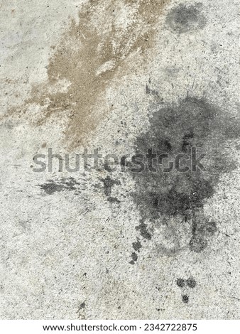 a photography of a dirty sidewalk with a black substance on it, on the ground with a black substance on it.