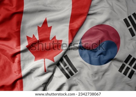 big waving realistic national colorful flag of canada and national flag of south korea . macro