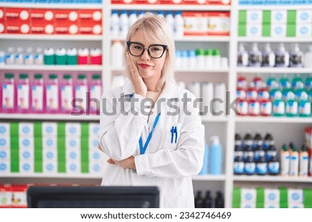 Young caucasian woman working at pharmacy drugstore thinking looking tired and bored with depression problems with crossed arms.  Royalty-Free Stock Photo #2342746469