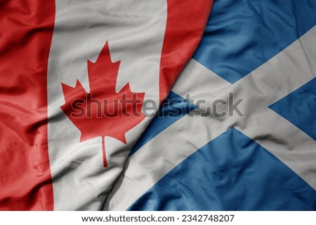 big waving realistic national colorful flag of canada and national flag of scotland . macro