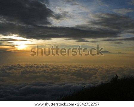 beautiful clouds at sunrise on Mount Merbabu with Mount Lawu in the background. The photo was taken by Willem Tasiam, a marathon climber