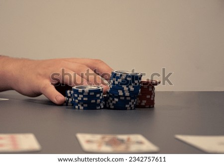 Hand pushing poker chips for all-in. Picture without a face.