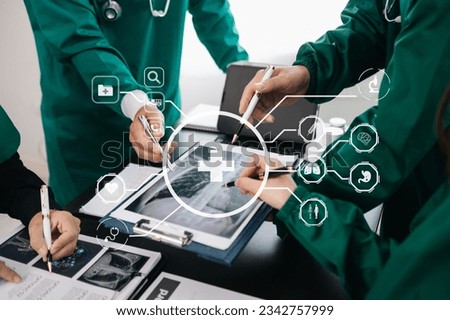 Medical technology network team meeting concept. Doctor hand working with smart phone modern digital tablet and laptop computer with graphics chart interface, with virtual icon 
