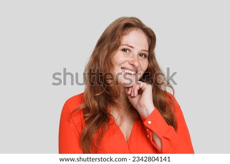 Attractive mature woman smiling on white background