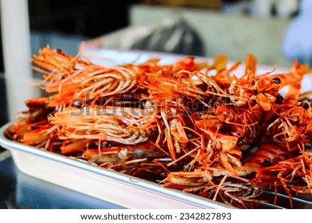 deep fried red prawn heads in a metalware Royalty-Free Stock Photo #2342827893