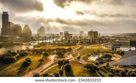 An aerial view of the Houston skyline, featuring the city's tall buildings, illuminated against the evening sky