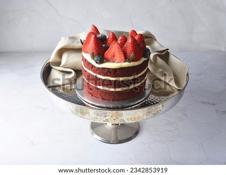freshly handmade beautiful wedding birthday ice cream cake red velvet w strawberry blueberry fruit on white marble luxury background with wood plate flower decoration halal food dessert menu for cafe