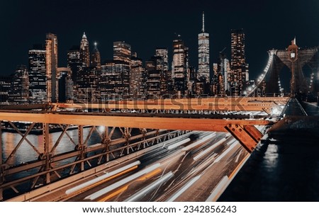 Car lights on the Brooklyn Bridge with New York Skyline, USA