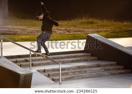 Boy doing skateboard trick in skatepark
