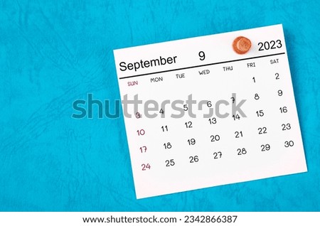 September 2023 and wooden push pin on blue background. Royalty-Free Stock Photo #2342866387