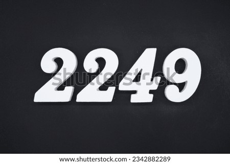 Black for the background. The number 2249 is made of white painted wood.
