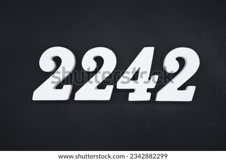 Black for the background. The number 2242 is made of white painted wood.