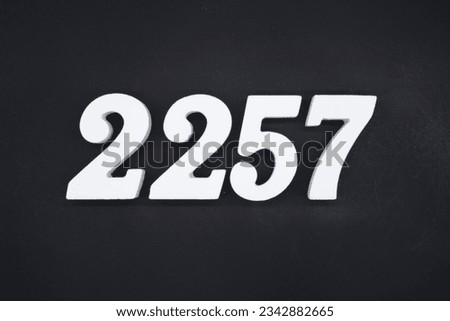 Black for the background. The number 2257 is made of white painted wood.
