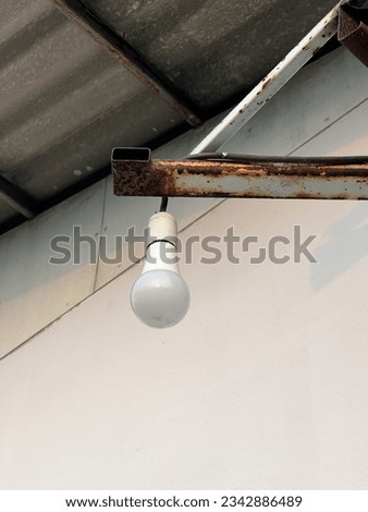 light bulb hanging on iron pole
