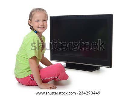The little girl looks at tv isolated