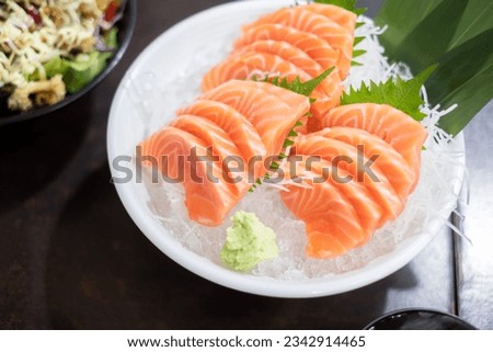 Fresh sliced salmon or salmon sashimi with in white bowl set on table, Japanese food.