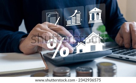 Businessman using calculator to calculate the bank interest rate for real estate, buy and sell house hight percentage, financial profit return, ROI, ROE, IRR. Royalty-Free Stock Photo #2342936575