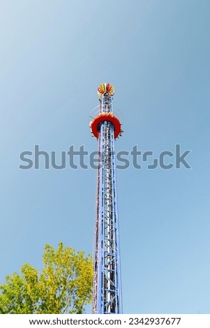 Suspended in mid-air, the free fall tower ride captures a moment of pure adrenaline rush as daredevils plummet, embracing the ultimate thrill at the amusement park.