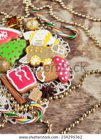 Homemade christmas painted gingerbreads on the wooden background with Christmas decorations. Selective focus and place for text. Toned