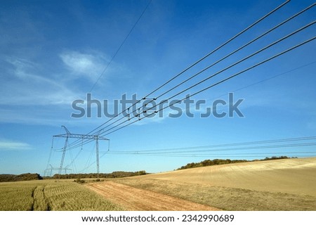 High voltage tower with electric power lines transfening electrical energy through cable wires