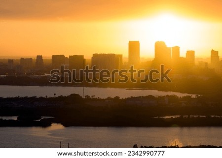 Aerial view of downtown district of Tampa city in Florida, USA at sunset. Dark silhouette of high skyscraper office buildings in modern american midtown