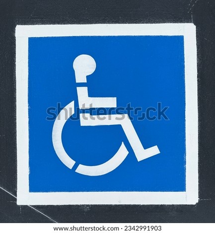 Freshly painted handicapped parking stencil in parking lot.  Marin City, Sausalito, CA, USA. 2023.