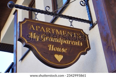                                A family house sign proudly displays the warmth of a home, bearing the family name and address with a heartfelt welcome, a symbol of comfort and belonging.