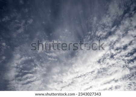 Blue sky with wispy white cloud pattern. Beautiful cloudscape texture background. 