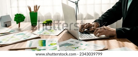 Eco business company office, businessman using laptop to plan business strategic marketing of eco-friendly and clean sustainable energy products. Green business company concept. Trailblazing Royalty-Free Stock Photo #2343039799