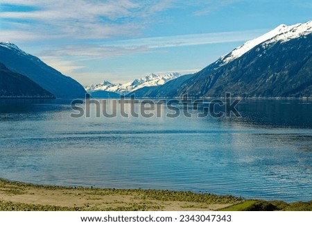 Snow Capped Mountains Beyond Icy Lagoon near Skagway, Alaska Royalty-Free Stock Photo #2343047343