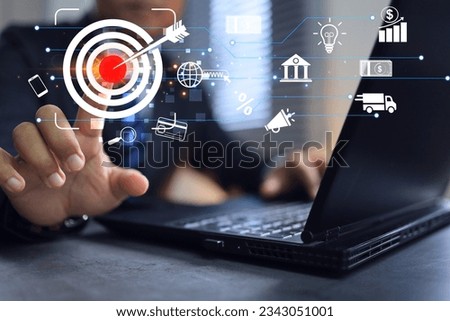 Businessman set goal or target on dartboard in office to sell products with design idea advertising banking payment customer access discounts and promotions to attract customers, free oversea shipping Royalty-Free Stock Photo #2343051001