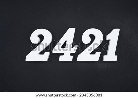 Black for the background. The number 2421 is made of white painted wood.